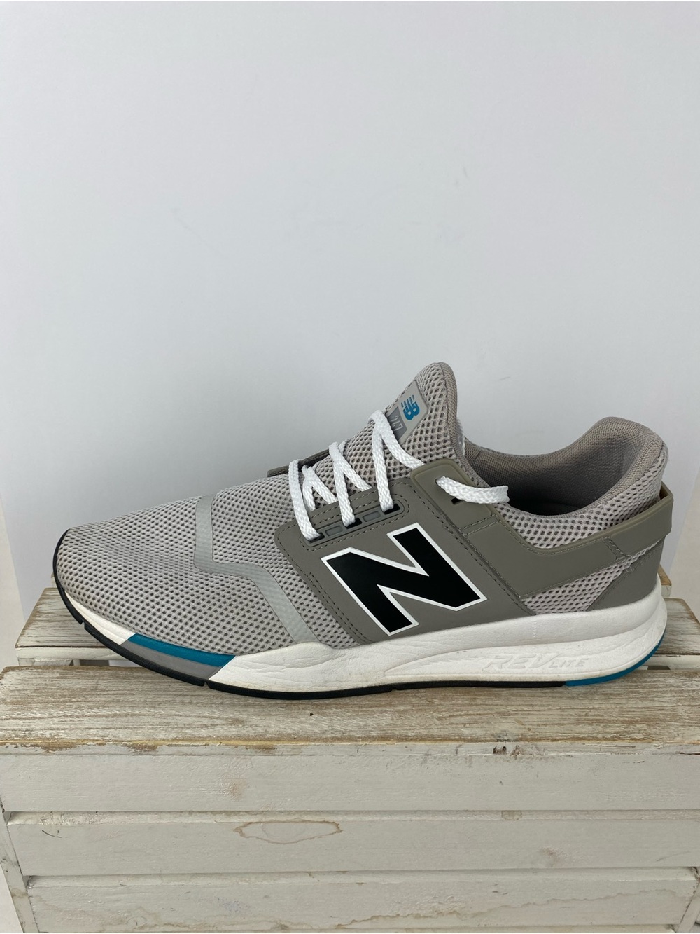 New Balance 247 sneakers with teal blue accents on the midsole men’s size 12